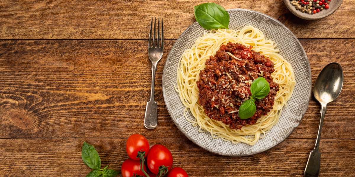 Spaghetti with meat sauce and tomatoes on a plate.
